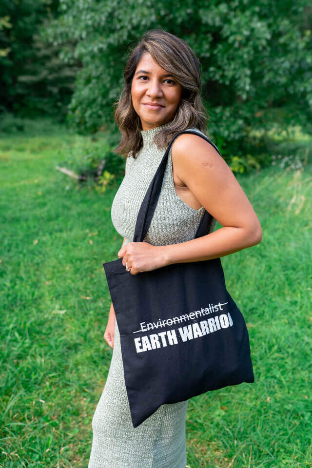 Lady holding earth warrior black canvas tote bag